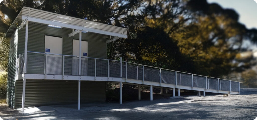 LooCube™ campground toilet facility with two cubicles and an accessible ramp.
