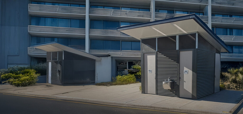 Two LooCube™ toilet buildings positioned in front of a commercial zone.