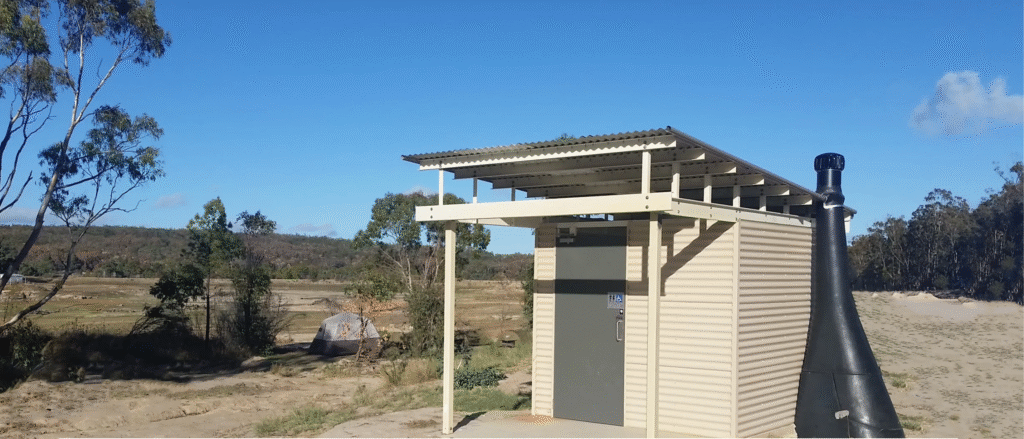 Accessible cubicle with level, step-free entry using a Kazuba™ waterless dry toilet system.
