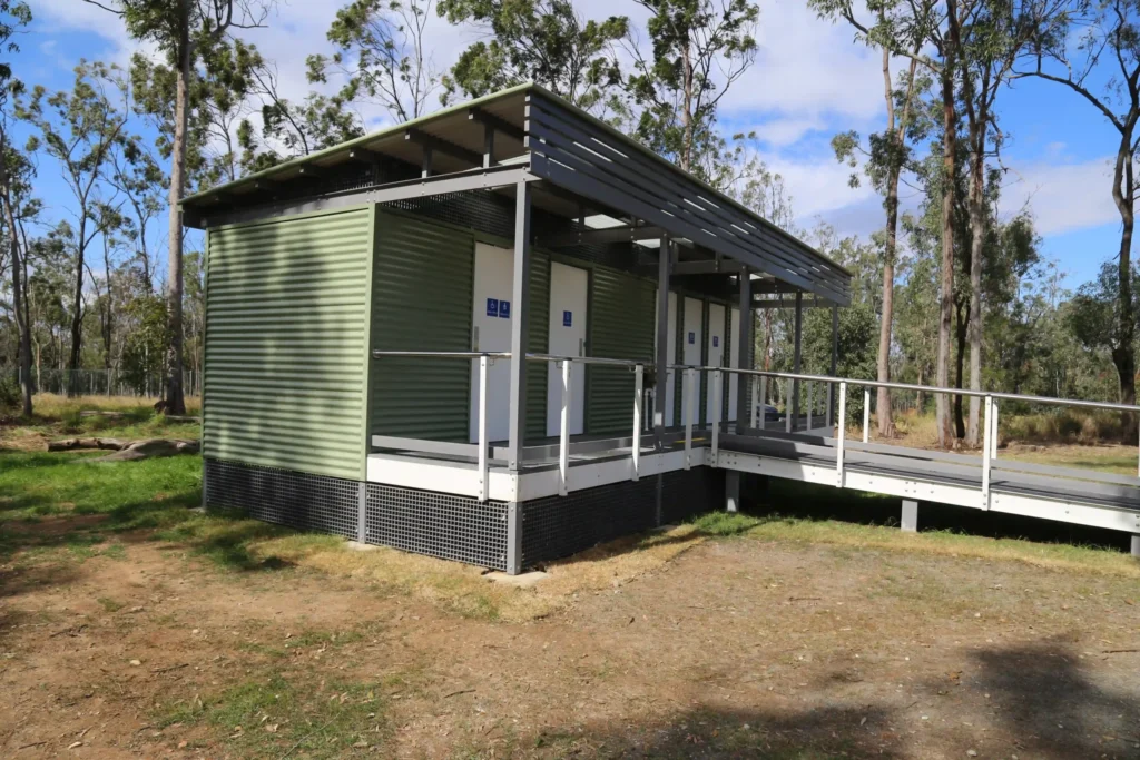 Queensland TMR public toilet building with six cubicles and accessible ramped entry.
