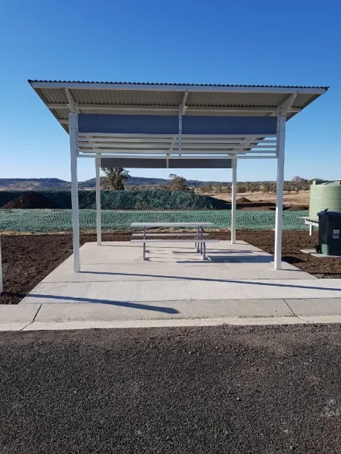 Close-up of Toowoomba shade structure with a picnic table beneath, adjacent to the truck stop amenities.
