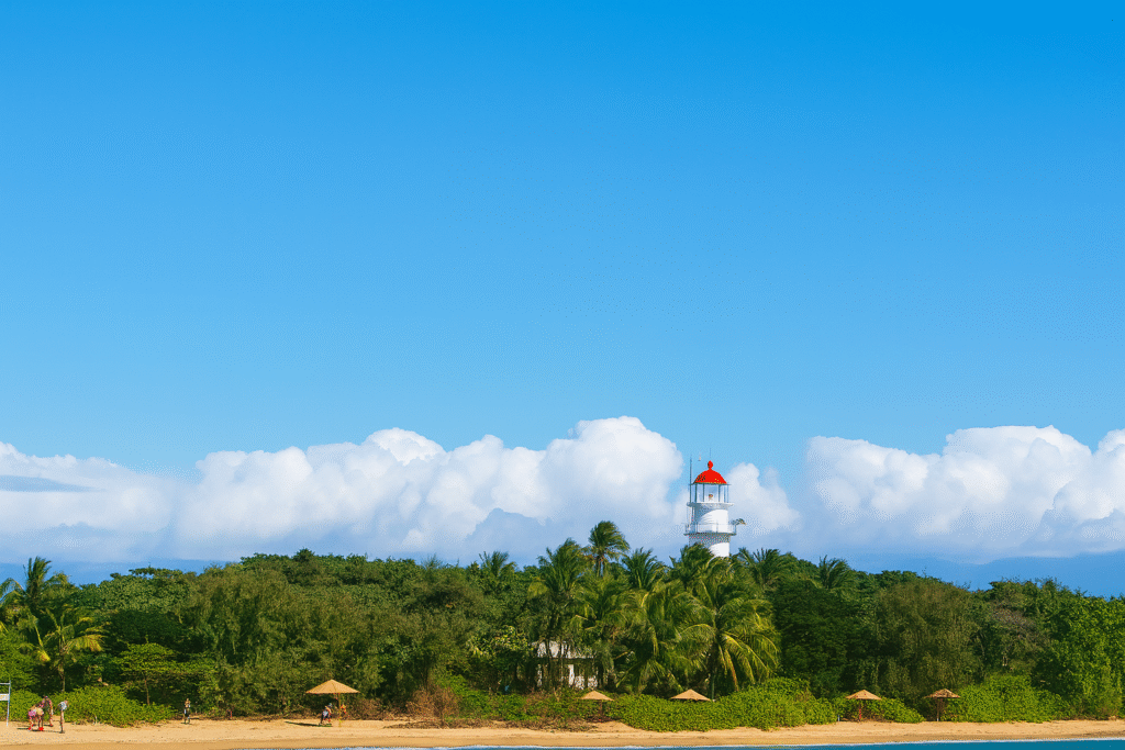 Distant view of Low Isles with lighthouse visible; people playing on the beach.