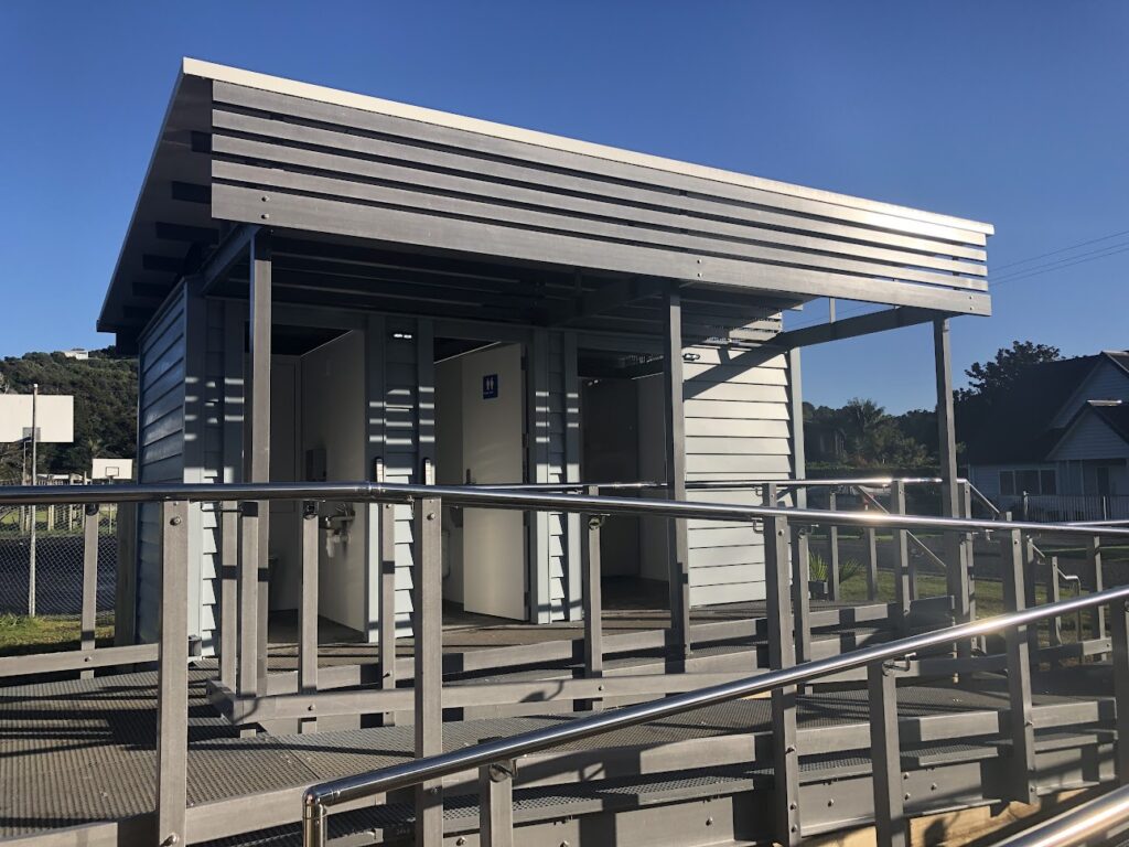 Three-cubicle composting public toilet in Matapōuri with accessible ramp; commissioned by Whangarei District Council.