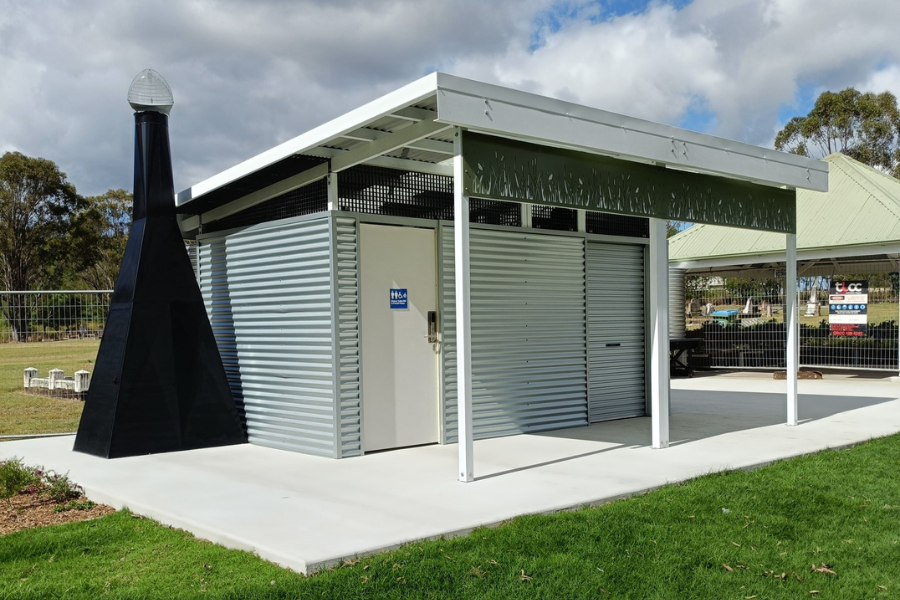 LooCube™ modular public toilet on slab with accessible cubicle, storage room, and desiccating dry toilet.